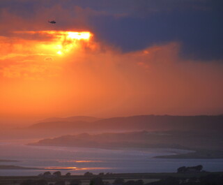 Coastguard helicopter at sunset